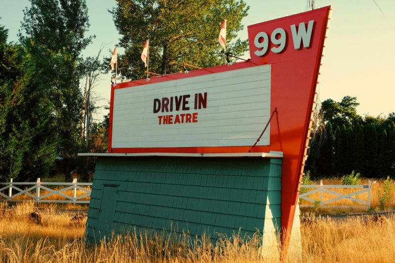 A vintage 99W Drive In Theatre sign in the countryside