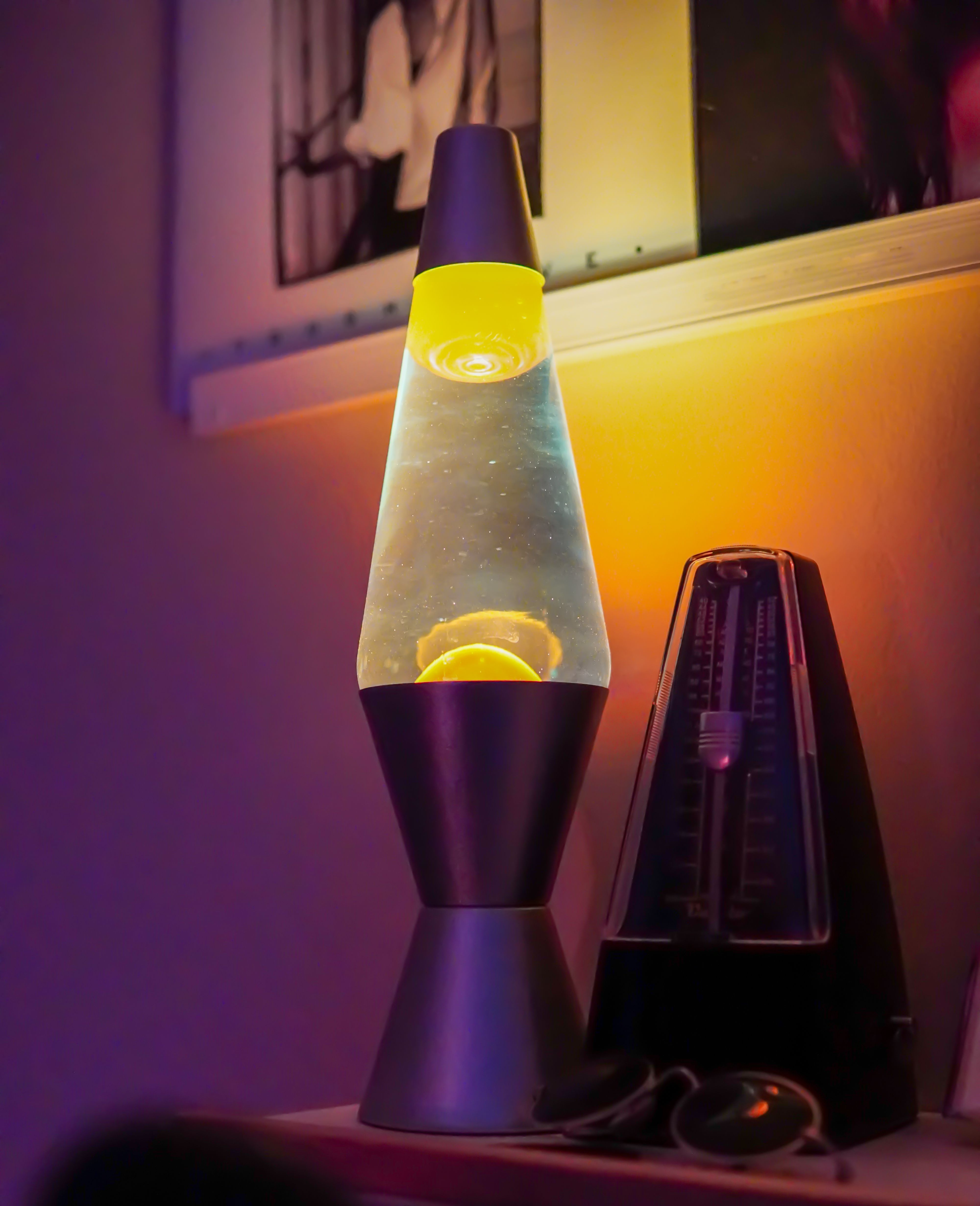 A glowing lava lamp with warm wax rising in glass