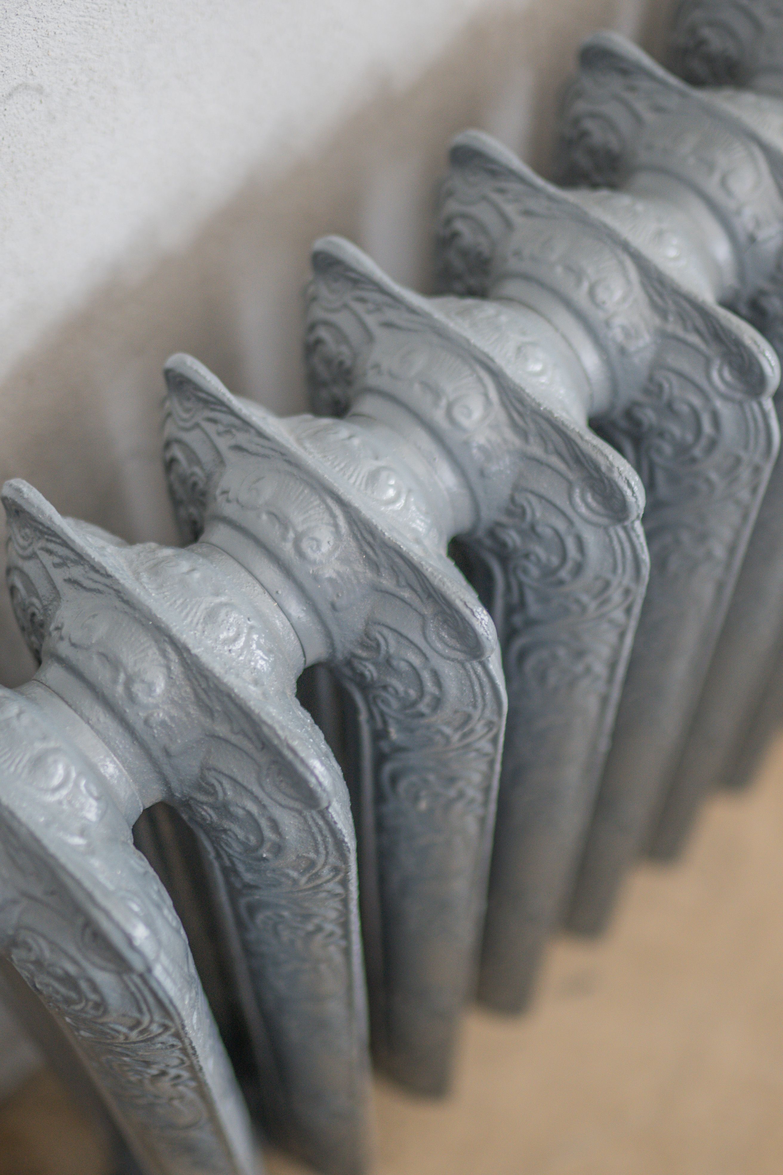 Detailed close-up of an ornate vintage cast iron radiator